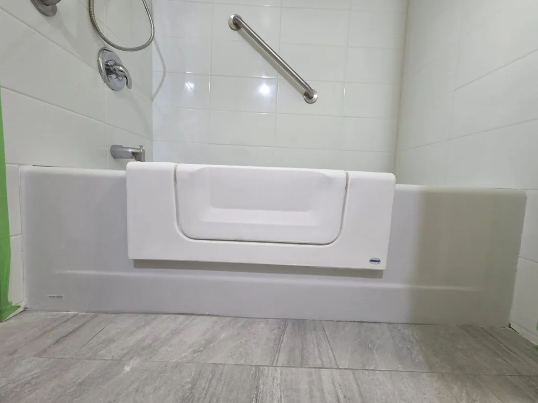 A tub step-through cut-out with a stainless grab bar, Quinte West