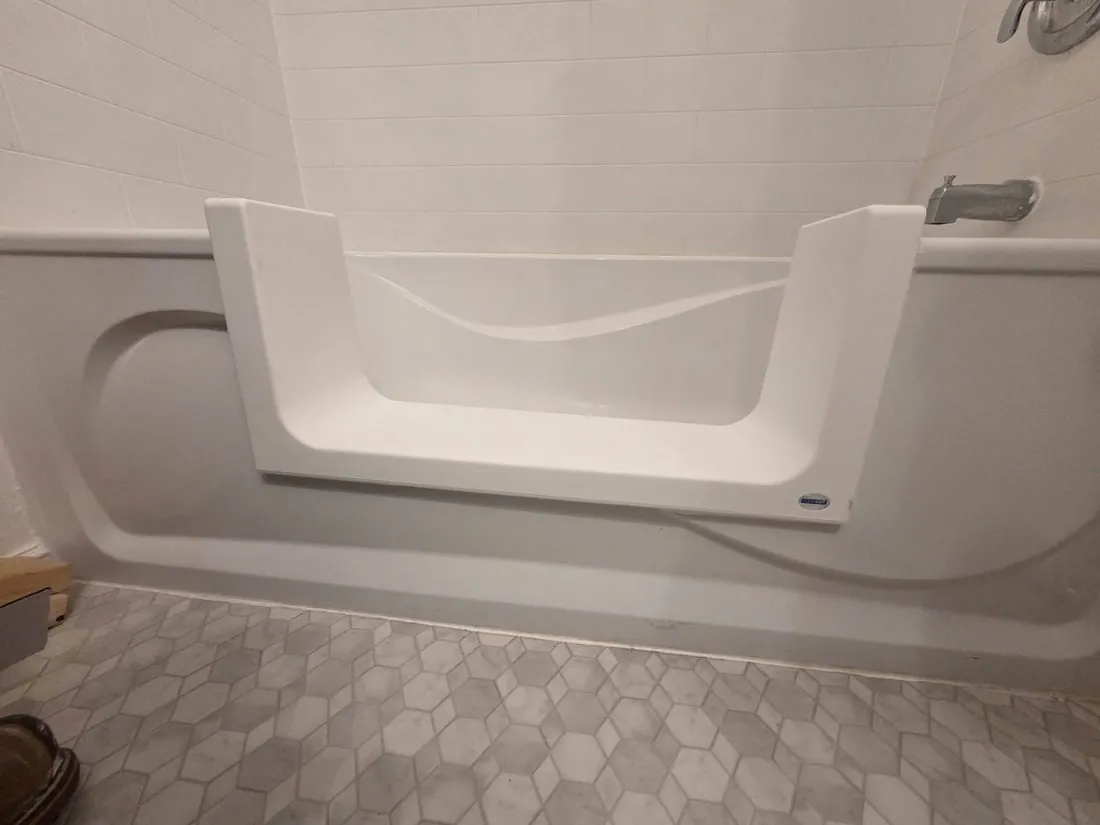 A finished low tub cut-out conversion with a grab bar in a Frankford bathroom