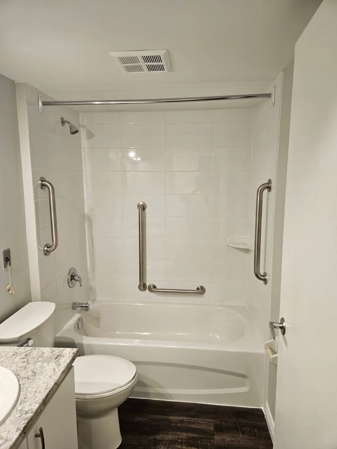 A finished tub-to-shower conversion with a grab bar in Trenton, Ontario
