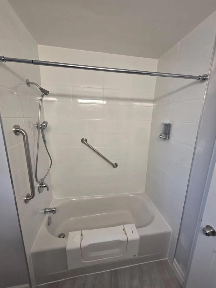 A tub-to-shower conversion with a vertical grab bar in Stirling