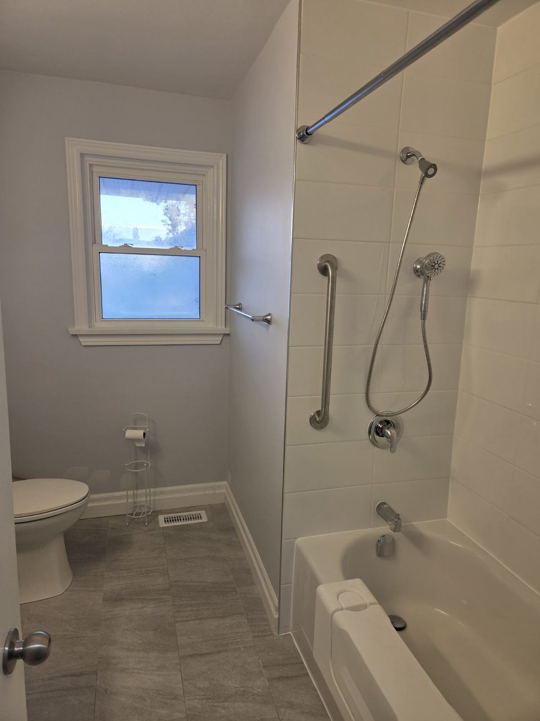 A walk-in shower with stainless grab bars installed in Picton