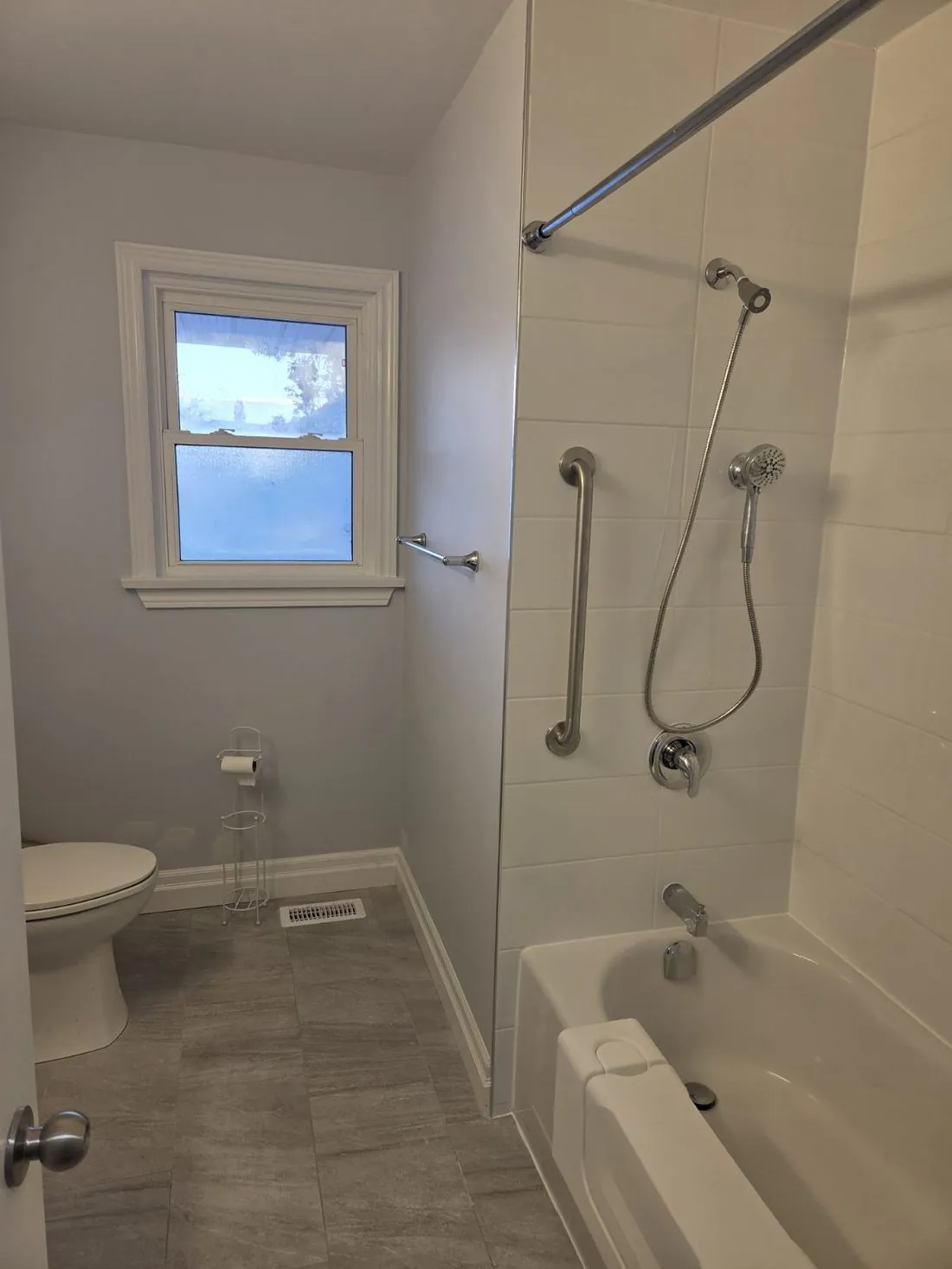 A walk-in shower with stainless grab bars installed in Picton